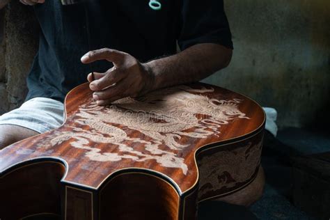 gianyar bali indonesia may 30 2019 a guitar craftsman are carving a