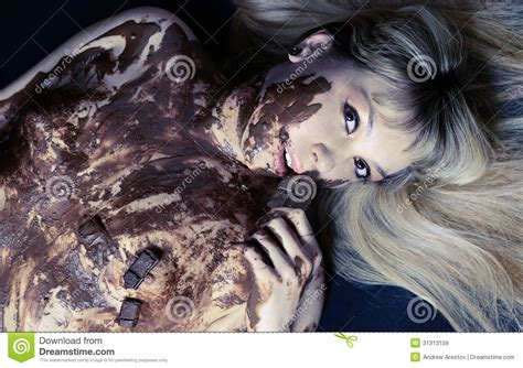 The Girl Covered With Hot Chocolate Lies On A Black Background Stock