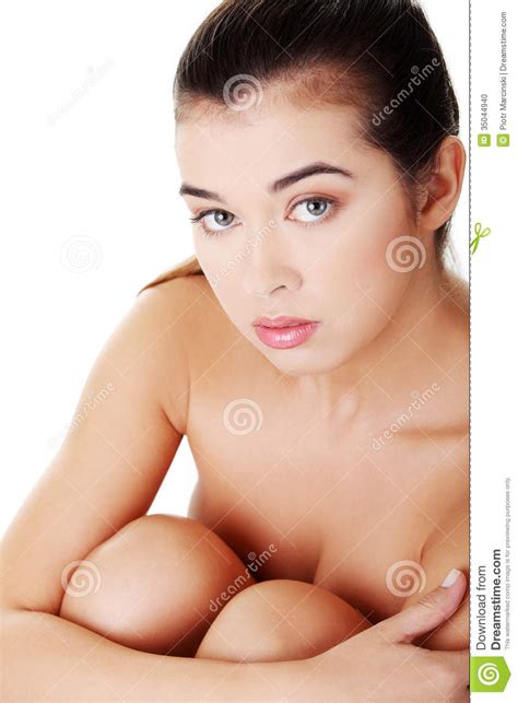 Naked Woman Sitting Holdig Knees Up Front View Stock