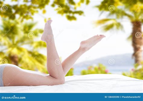 young white woman  beautiful long legs  summer day  bed stock