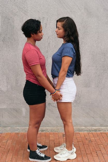 premium photo latina lesbian couple stare at each other during a date
