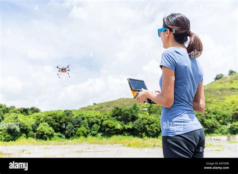 young woman remote flying drone stock photo alamy