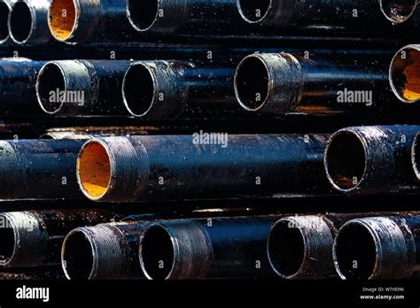 view  drilling pipes casing  tubing stacked  open yard  oil  gas warehouse stock