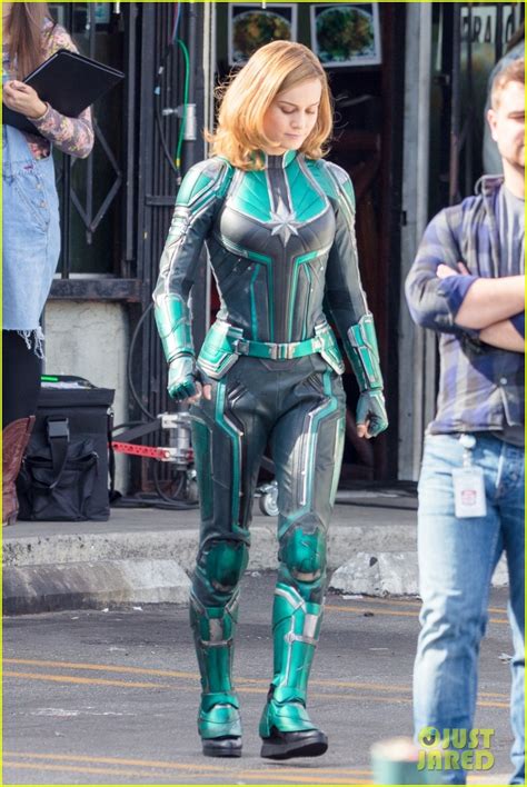 brie larson gets into her superhero costume as captain marvel see the first pics from the