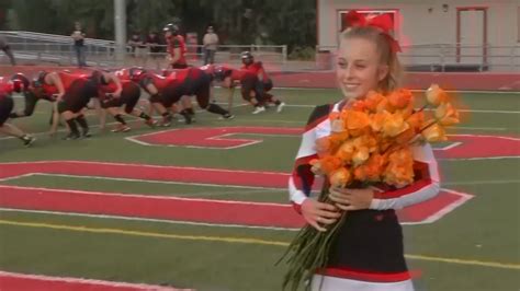 cheerleader gets touching surprise from football team