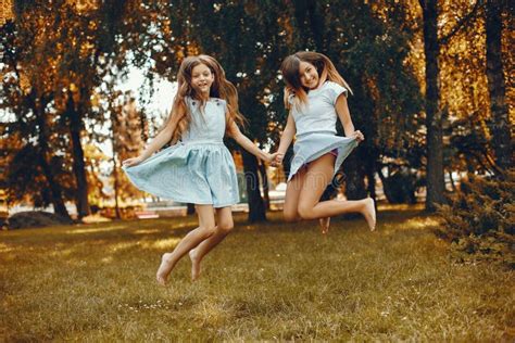 Two Cute Girls Have Fun In A Summer Park Stock Image Image Of Looking