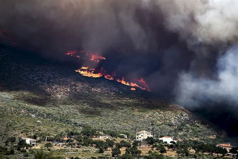 greece fire rages   hills  athens causing residents  flee