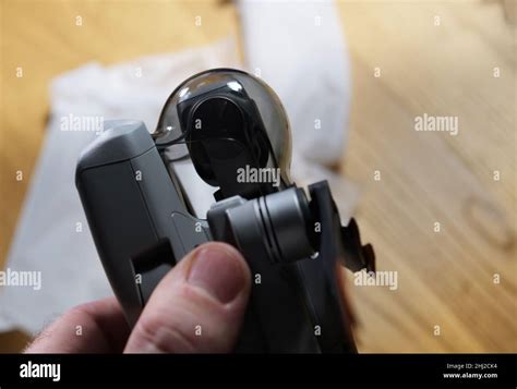 male hand holding gimbal protector   small drone   unboxing stock photo alamy