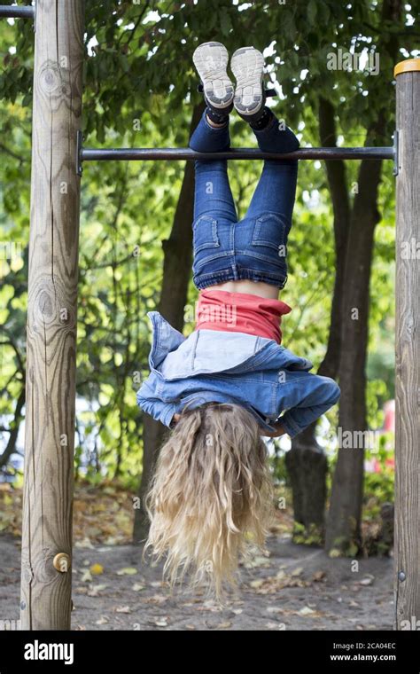 girl  hangs upside   horizontal bar kiel schleswig holstein