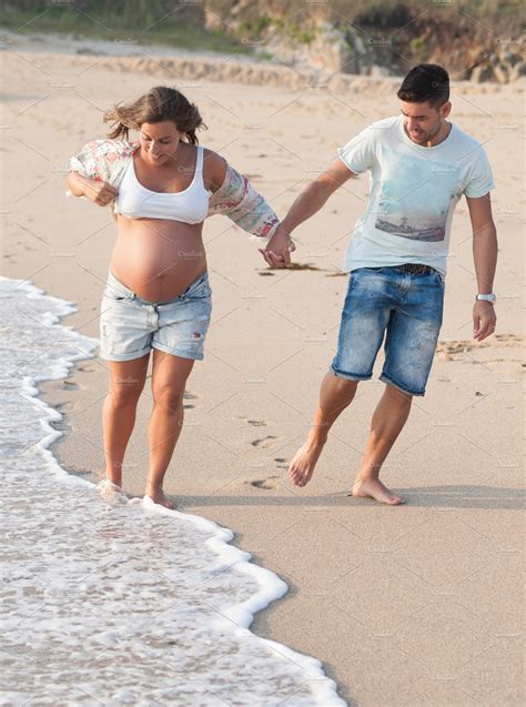 Happy Pregnant Couple On Beach High Quality People Images ~ Creative