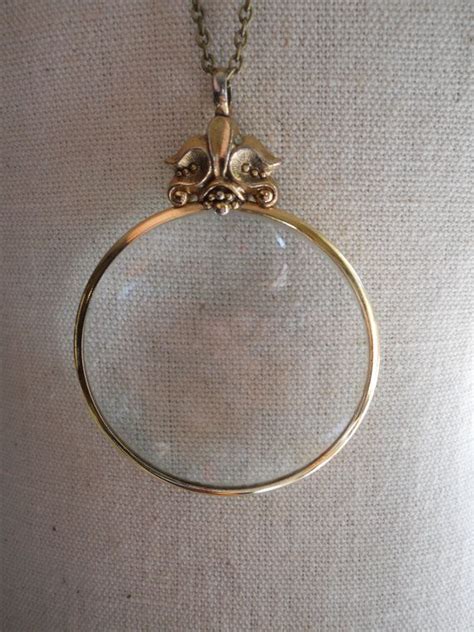 vintage magnifying glass necklace on long brass chain avon collection 1970s strong magnification