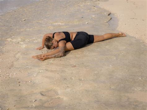 woman practicing yoga nature hanumanasana monkey pose stock