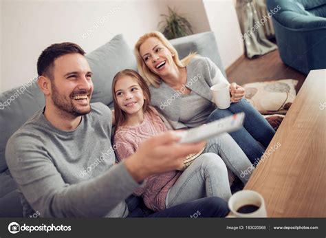 smiling young family watching  spending  time home stock photo  civanko