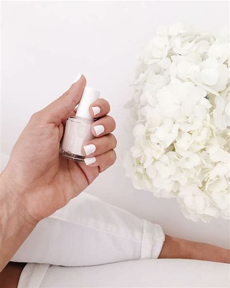 woman holding  bottle  nail polish    bouquet  white