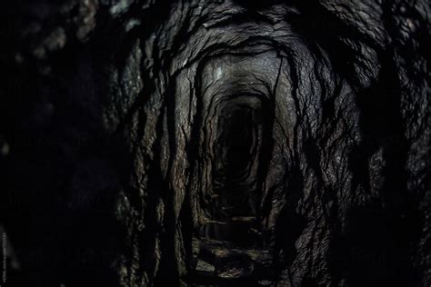 dark  intimidating cave leading   ominous hole stocksy united