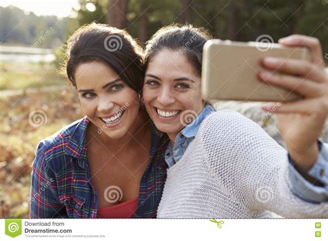 Lesbian Couple In The Countryside Taking A Selfie Stock