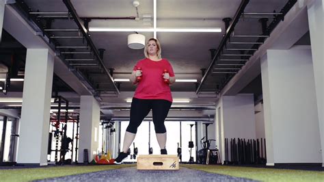 Overweight Woman In Gym Working Out Doing Box Steps Stock Video