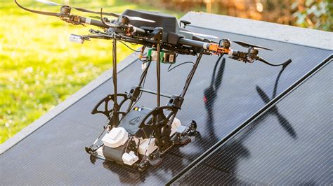 automated solar panel cleaning system doubles   drones