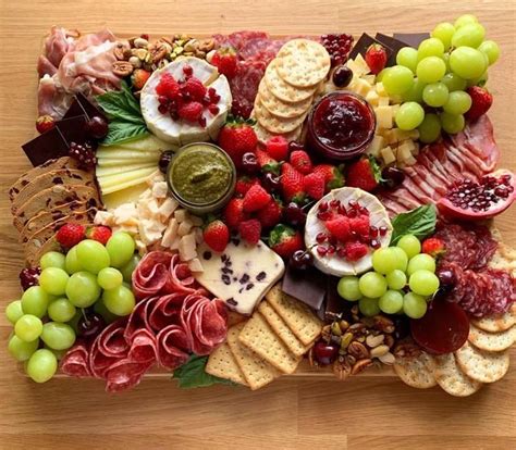 a platter filled with cheese fruit and crackers