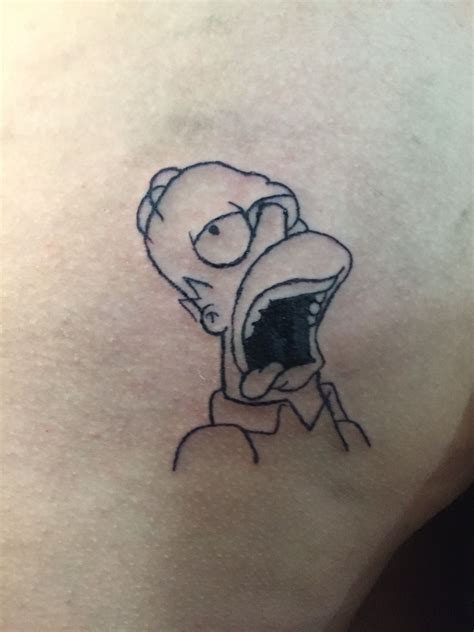 A Person With A Cartoon Character Tattoo On Their Back