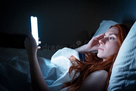 One Woman Holding Mobile Phone In Bed Late At Night Stock Image Image
