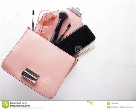 flat lay  female fashion accessories  pink handbag  white