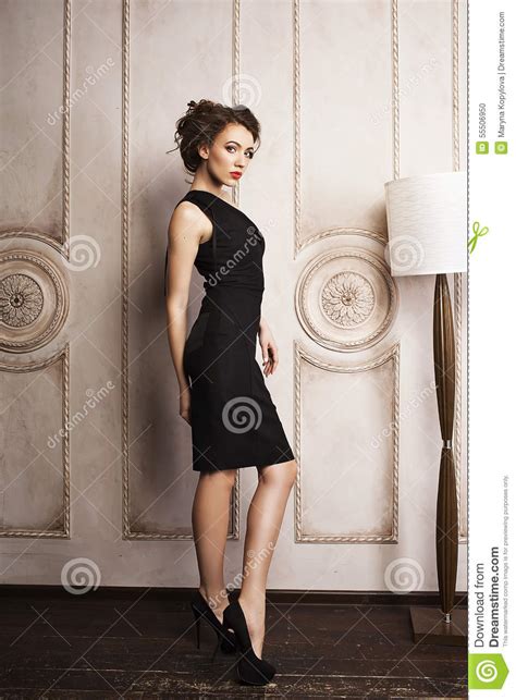Beautiful Elegant Woman In Black Dress Standing Near The