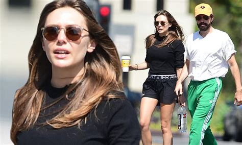elizabeth olsen highlights her toned legs as she and
