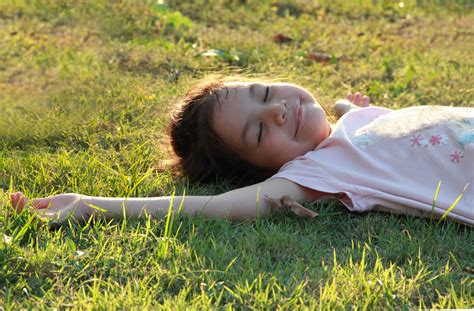Asian Girl Lie Down On Grasses Or Lawn Under Warm Osho Sammasati
