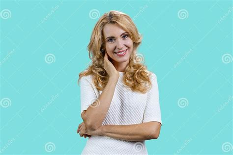 Portrait Of Happy Cute Mature Blonde Woman With Folded Arms Stock