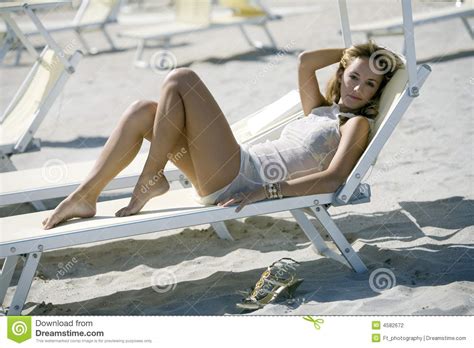 Beautiful Blonde Woman Lying Down On A Deck Chair Stock