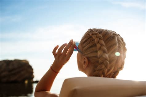 Beautiful Blonde Woman In Sunglasses Sunbathing Near Sea