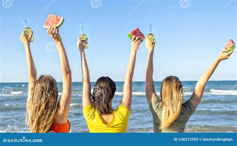 Three Happy Women Toasting Beers Looking At The Horizon Beach Outdoors
