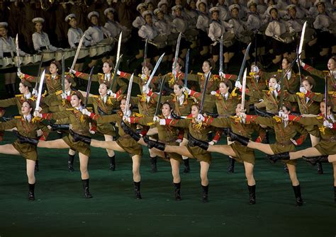 sexy north korean women dressed as soldiers dancing with swords during