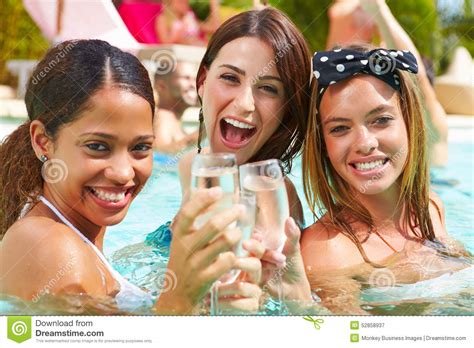 Three Women Having Party In Swimming Pool Drinking