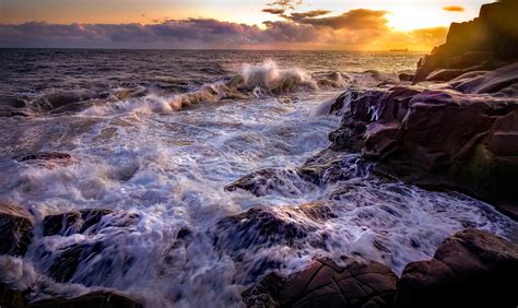 ocean waves crashing  rocks  sunset  stock photo