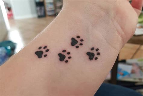 dog paw print tattoos  wrist  paws