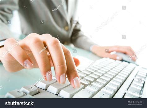 close   secretarys hand touching computer keys  work stock