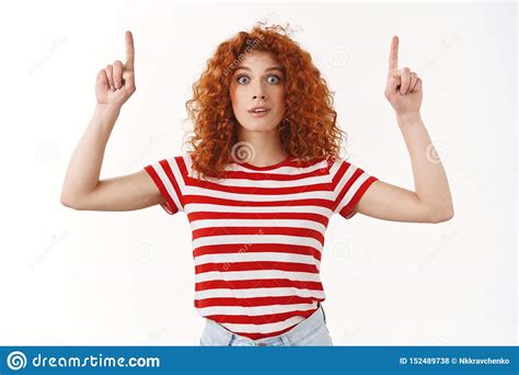 surprised stunned redhead attractive curly haired woman wide eyes hold