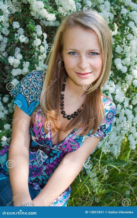 The Fair Haired Girl Sits In A Garden Stock Image Image Of Buds