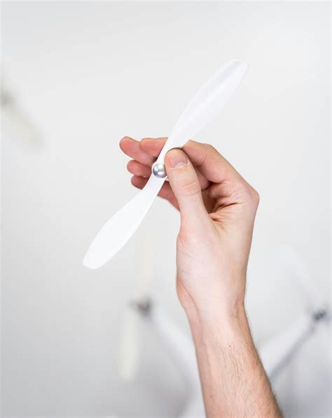 person holding white plastic spoon  stock photo
