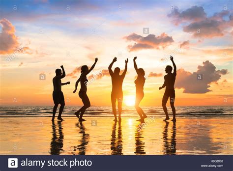 Group Of Happy People Having Fun Dancing At A Beach Party