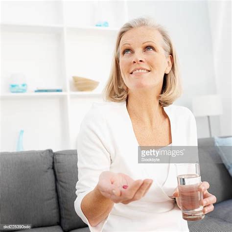 Mature Woman Holding Glass Of Water Photos And Premium High Res