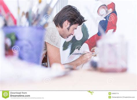 young painter painting  canvas painting session stock photo image  creativeness male