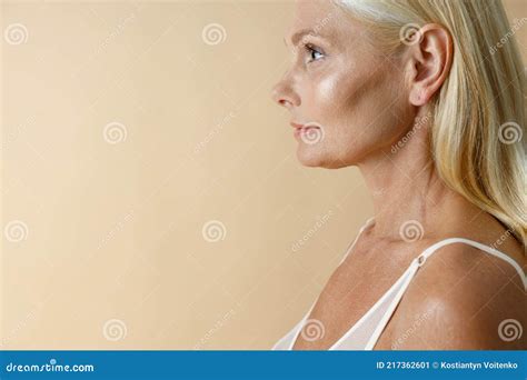 Side View Portrait Of Pretty Mature Blonde Woman In White Underwear