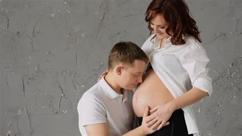 new father with head on belly of pregnant wife stock footage video 875374 shutterstock
