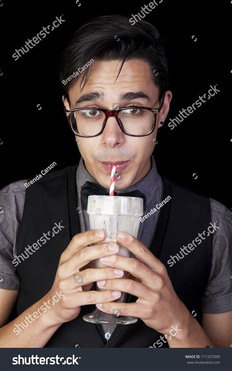 A Geeky Nerd Guy Sucking Chocolate Milkshake Through A Straw Stock