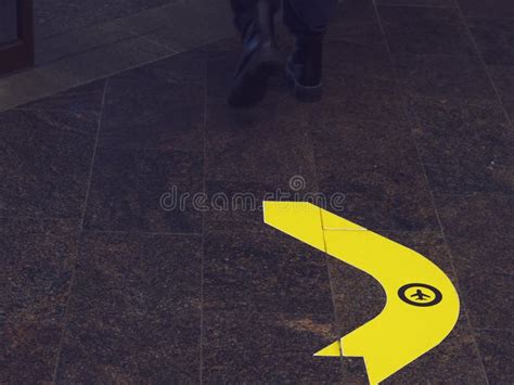 yellow curved arrow   airplane icon   marble floor boarding gate airport sign stock