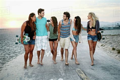 friends walking   beach stock photo dissolve