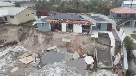 damaged homes dangle precariously  washed  florida